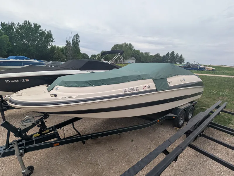 Slide: The Image of 2004 Larson Escape 234 boat with cover on trailer. - 4