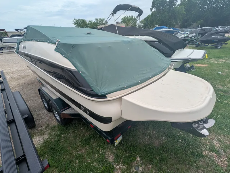 Slide: The Image of 2004 Larson Escape 234 boat with cover on trailer. - 5