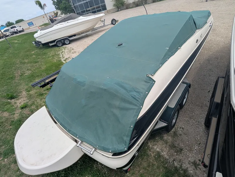 Slide: The Image of 2004 Larson Escape 234 boat with cover on trailer. - 7
