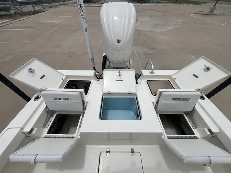 Slide: The Image of 2022 Pathfinder 2400 boat with open storage compartments and motor. - 26