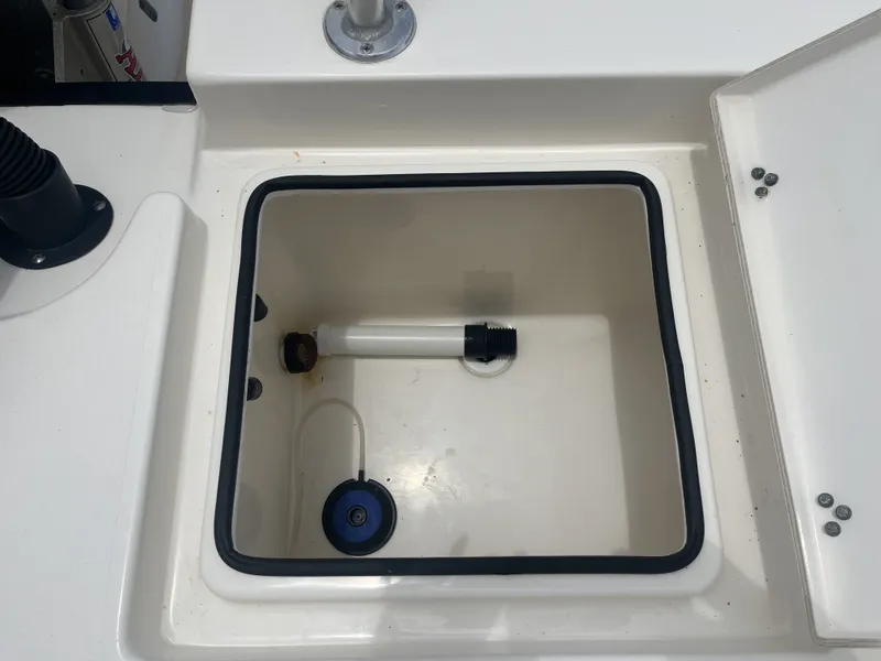 Slide: The Image of Pathfinder 2400 boat, 2022, open storage compartment with drain pipe. - 30