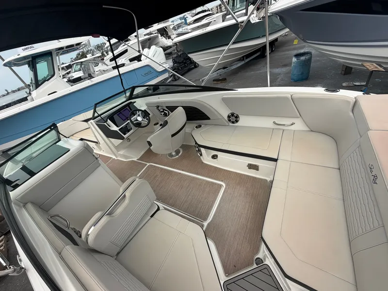 Slide: The Image of The interior of a Sea Ray SPX 230 Outboard boat with beige seating and a modern helm. - 10