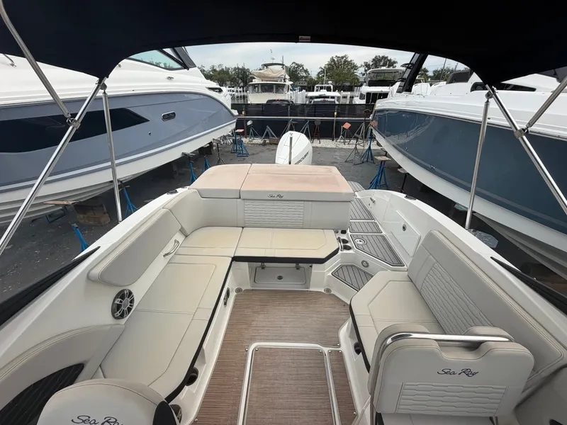 Slide: The Image of Interior view of a Sea Ray SPX 230 Outboard with sleek seating and wood flooring. - 11