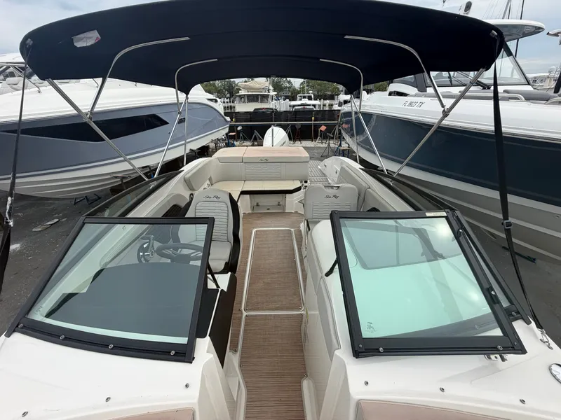 Slide: The Image of A Sea Ray SPX 230 Outboard boat with an open deck and sunshade. - 13