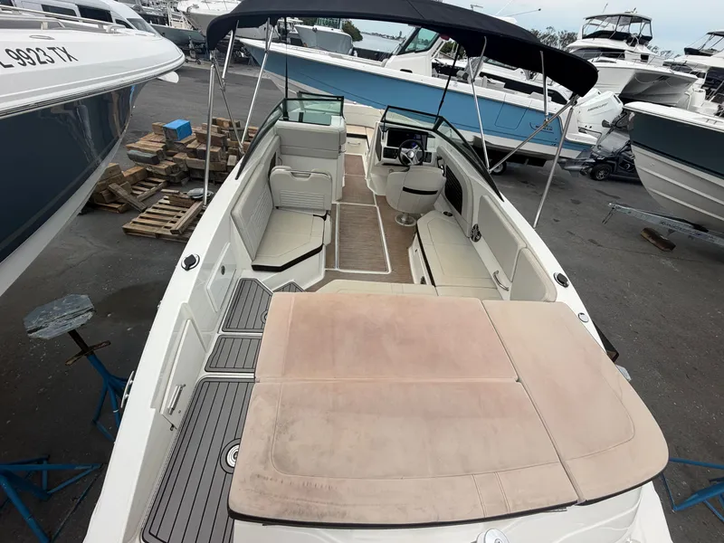 Slide: The Image of A Sea Ray SPX 230 Outboard boat is parked, surrounded by other boats. - 14
