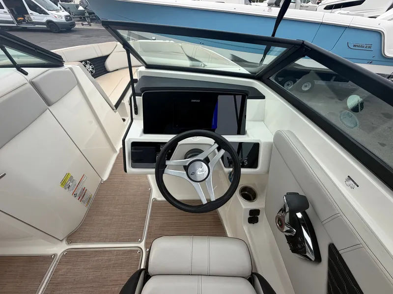 Slide: The Image of The cockpit of a Sea Ray SPX 230 Outboard with a modern steering wheel and instruments. - 15