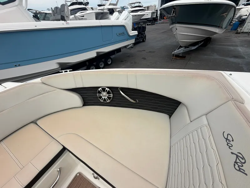 Slide: The Image of Interior view of a Sea Ray SPX 230 Outboard with beige upholstery and speaker. - 16