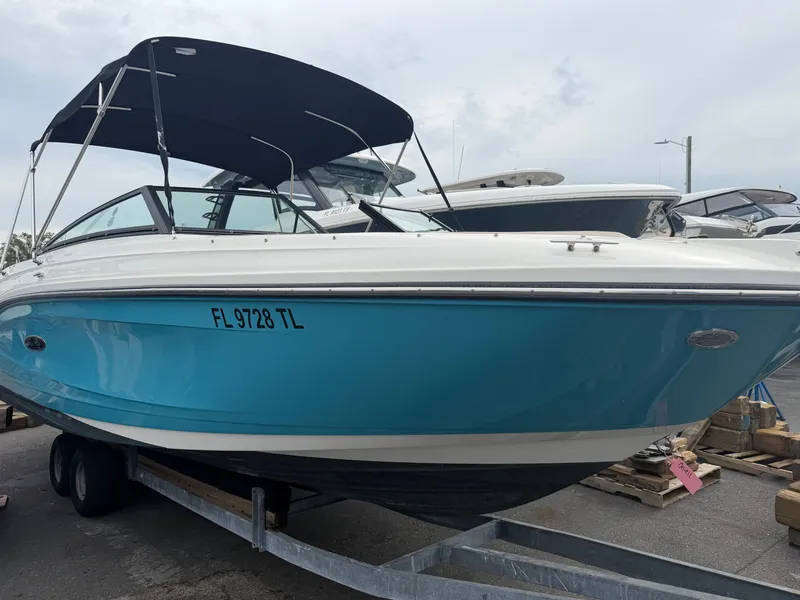 Slide: The Image of A Sea Ray SPX 230 Outboard boat on a trailer, featuring a blue hull and black canopy. - 2
