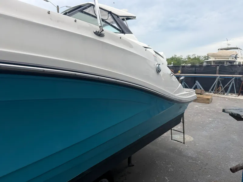 Slide: The Image of A Sea Ray SPX 230 Outboard boat is on land, resting on a stand. - 4