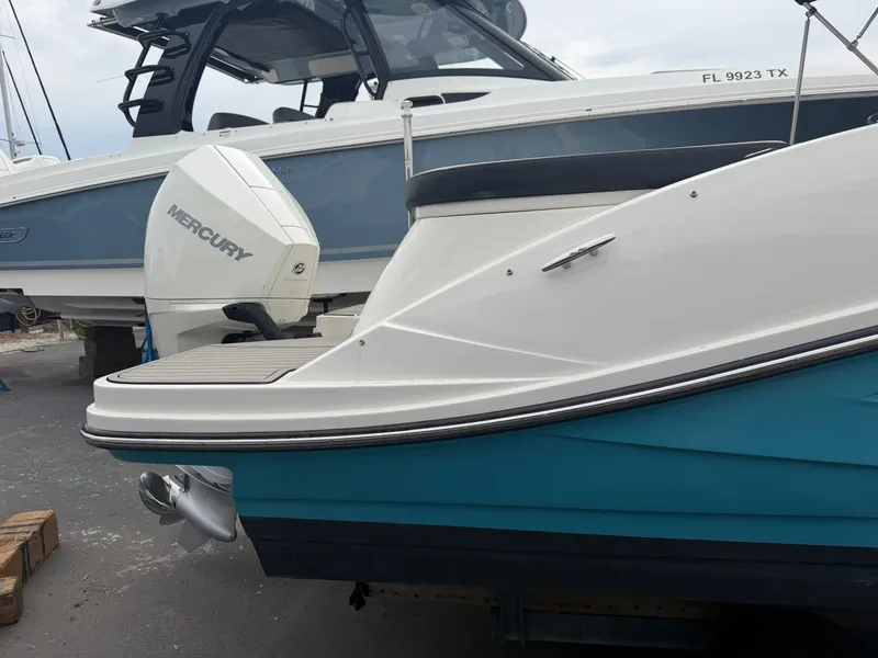 Slide: The Image of A Sea Ray SPX 230 Outboard boat is parked next to another boat. - 5