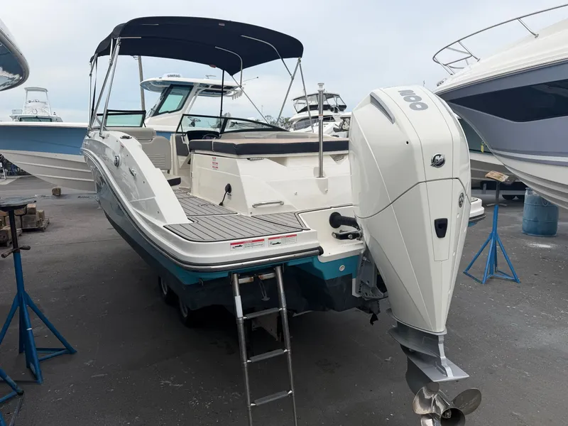 Slide: The Image of A Sea Ray SPX 230 Outboard boat is on a dry dock, surrounded by other boats. - 6