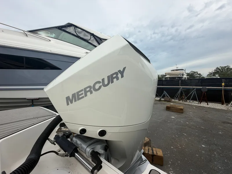 Slide: The Image of A Mercury outboard motor on a Sea Ray SPX 230 boat, positioned on land. - 8