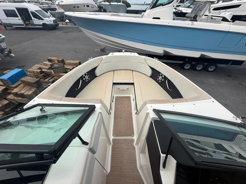 Slide: The Image of The Sea Ray SPX 230 Outboard boat is parked on a lot, surrounded by other boats. - 9