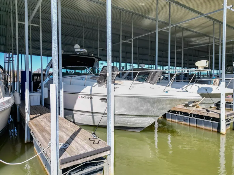 Slide: The Image of 2005 Cruisers Yachts 370 Express docked in a covered marina. - 1
