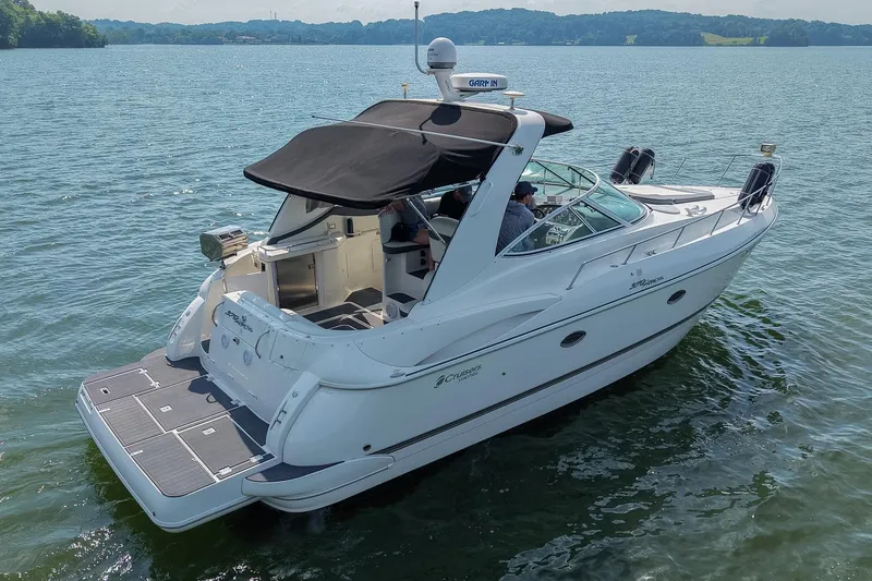 Slide: The Image of 2005 Cruisers Yachts 370 Express on serene lake waters, rear view. - 11