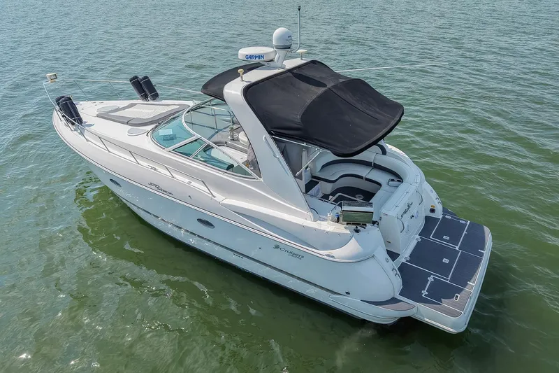Slide: The Image of 2005 Cruisers Yachts 370 Express on water, featuring sleek design and spacious deck. - 13