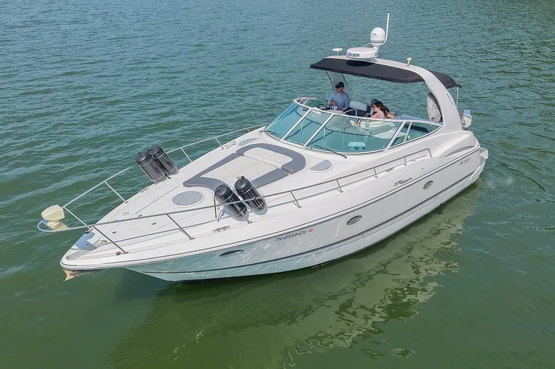 Slide: The Image of 2005 Cruisers Yachts 370 Express on calm water, featuring sleek design and spacious deck. - 15