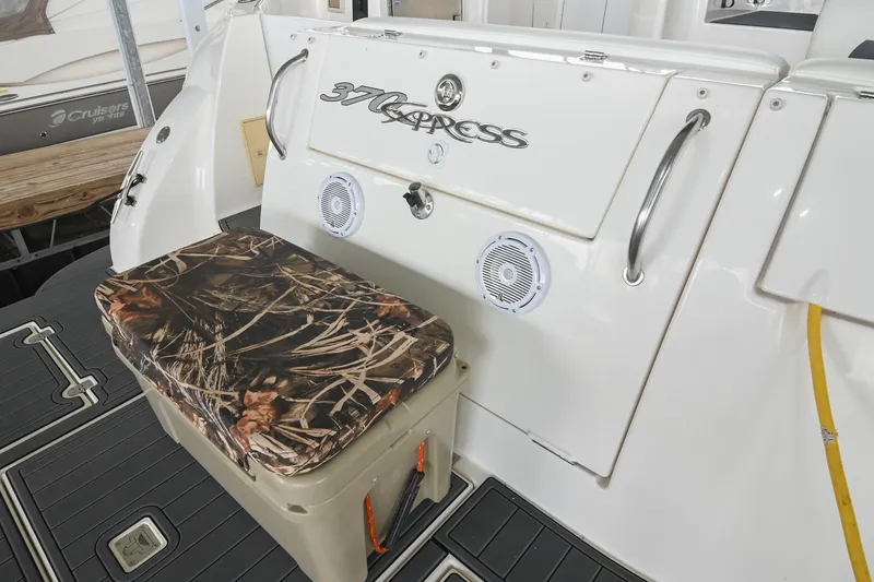Slide: The Image of 2005 Cruisers Yachts 370 Express boat with camo seat and speakers on deck. - 19