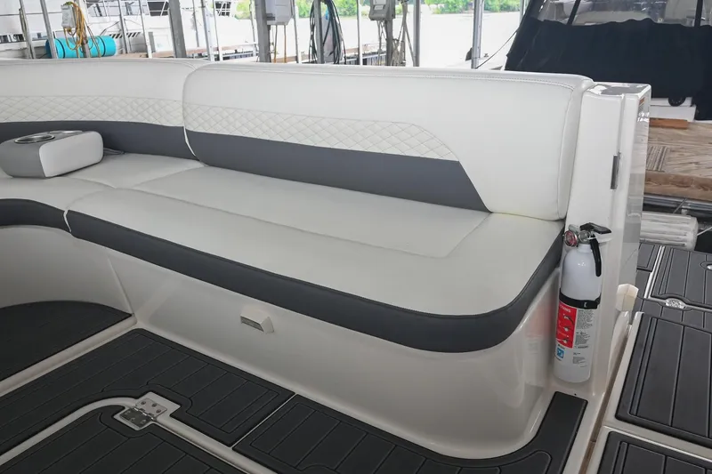 Slide: The Image of 2005 Cruisers Yachts 370 Express interior seating with fire extinguisher, docked setting. - 22