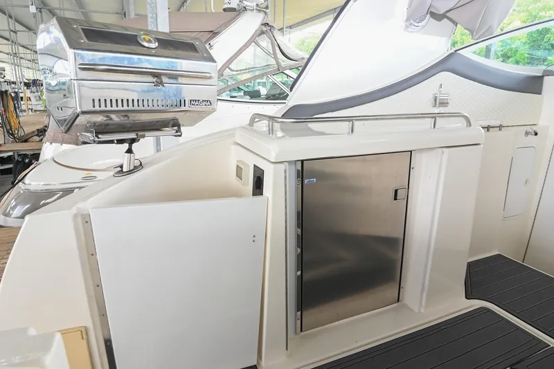Slide: The Image of 2005 Cruisers Yachts 370 Express with outdoor grill and storage area. - 25