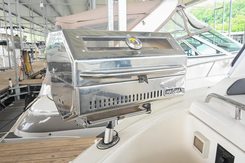 Slide: The Image of Stainless steel grill on 2005 Cruisers Yachts 370 Express, docked in a marina. - 26