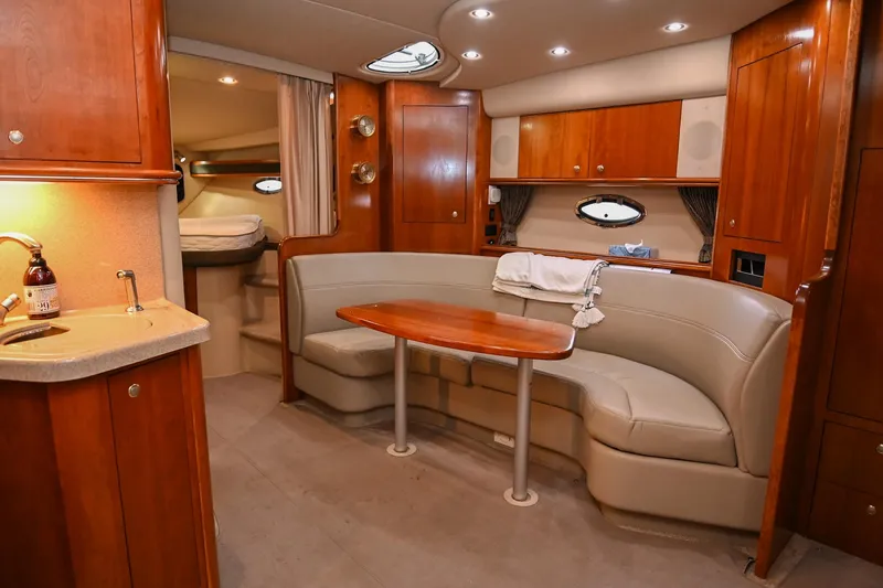 Slide: The Image of Luxurious 2005 Cruisers Yachts 370 Express interior with elegant wood finishes and cozy seating. - 29
