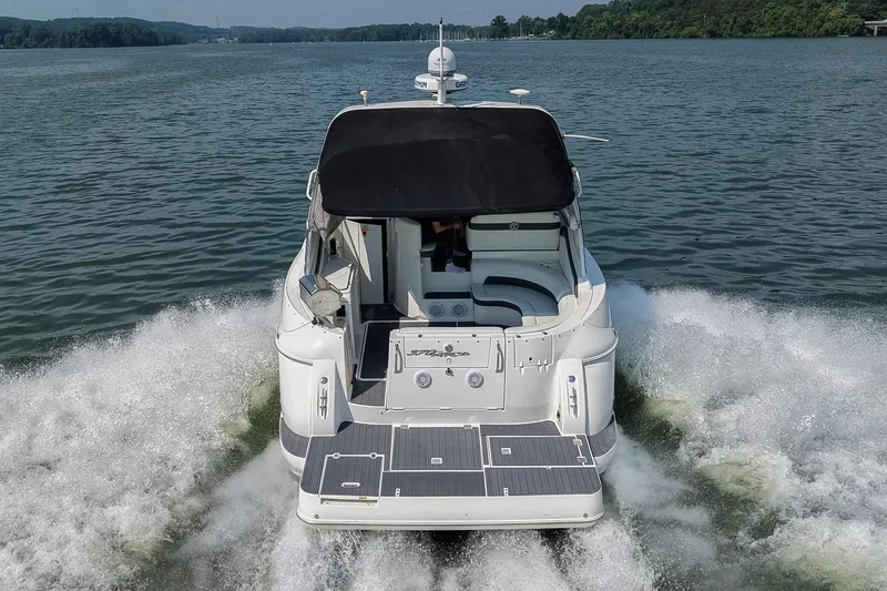Slide: The Image of 2005 Cruisers Yachts 370 Express cruising on a lake, rear view. - 3