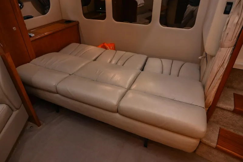 Slide: The Image of 2005 Cruisers Yachts 370 Express interior with beige leather seating and wooden accents. - 36