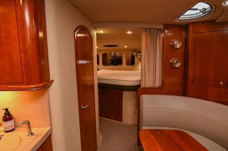 Slide: The Image of Interior of 2005 Cruisers Yachts 370 Express, featuring cozy cabin and wooden finishes. - 40