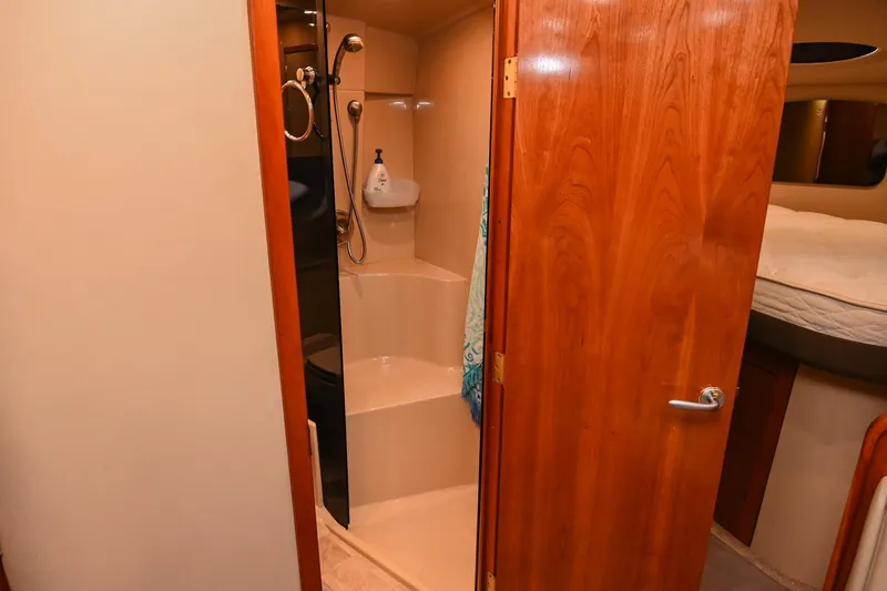 Slide: The Image of 2005 Cruisers Yachts 370 Express bathroom with shower and wooden door. - 41