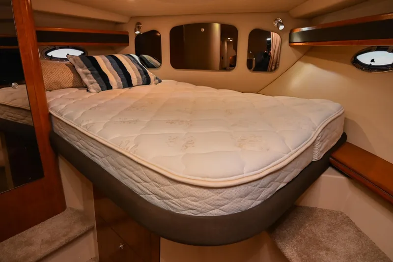 Slide: The Image of 2005 Cruisers Yachts 370 Express cabin with cozy bed and elegant interior design. - 47