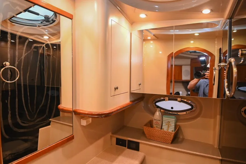 Slide: The Image of Luxurious bathroom interior of 2005 Cruisers Yachts 370 Express with mirrored cabinets. - 58