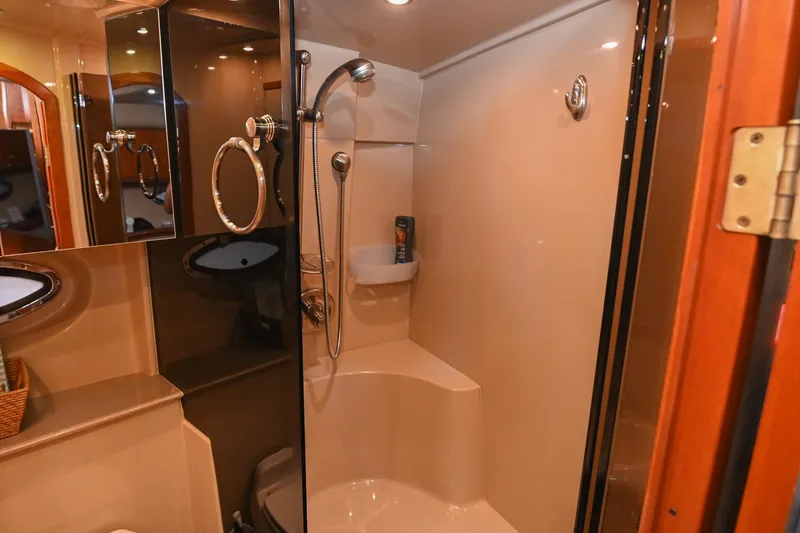 Slide: The Image of Luxurious bathroom in 2005 Cruisers Yachts 370 Express, featuring modern fixtures and elegant design. - 59