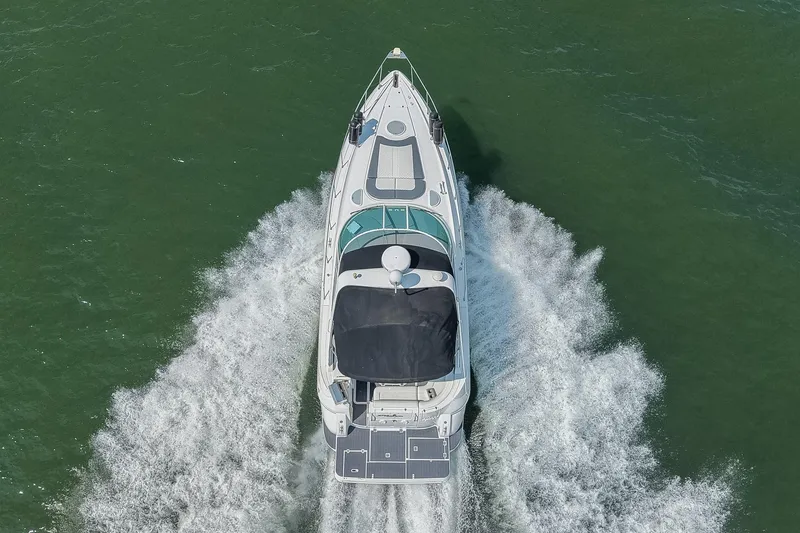 Slide: The Image of 2005 Cruisers Yachts 370 Express cruising on open water, aerial view. - 6