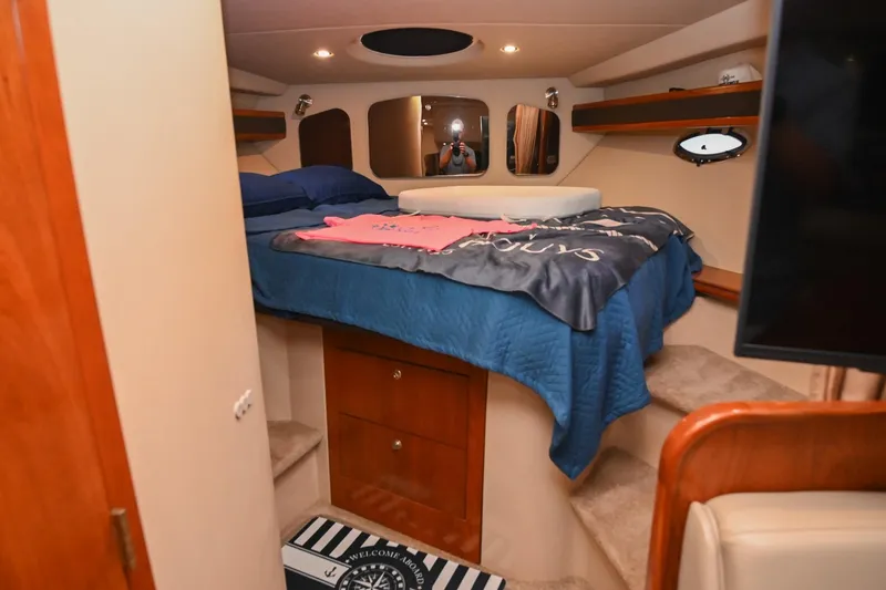 Slide: The Image of Cozy cabin interior of 2005 Cruisers Yachts 370 Express with bed and storage. - 60