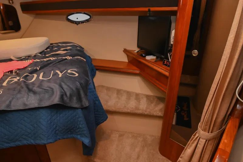 Slide: The Image of Cozy cabin interior of 2005 Cruisers Yachts 370 Express with bed and TV. - 61