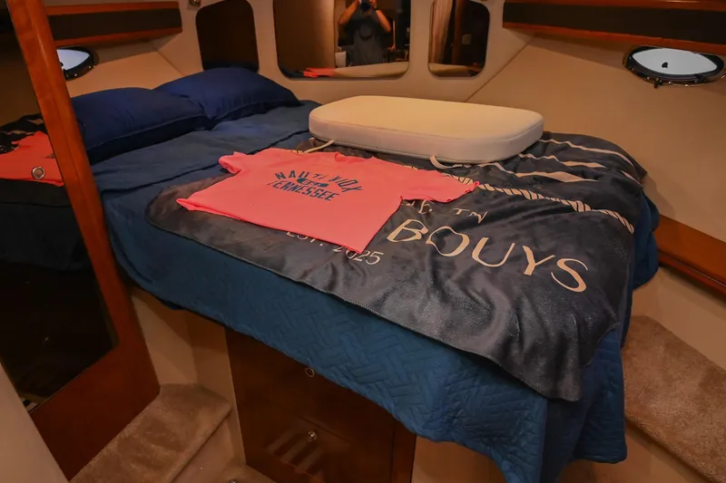 Slide: The Image of Cozy cabin interior of 2005 Cruisers Yachts 370 Express with bed and nautical decor. - 64