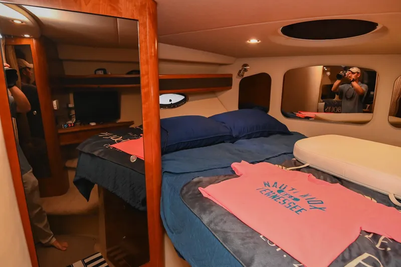 Slide: The Image of Interior of 2005 Cruisers Yachts 370 Express with cozy bedroom and nautical decor. - 65