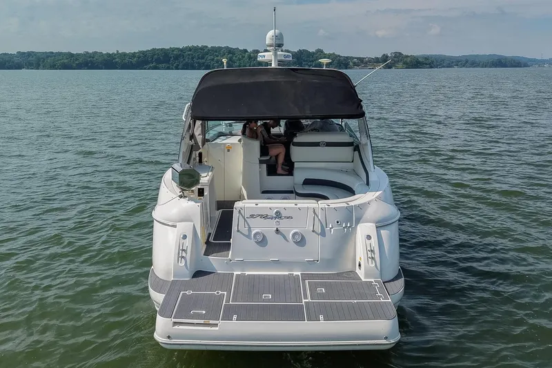 Slide: The Image of 2005 Cruisers Yachts 370 Express on calm water, rear view with canopy and seating area. - 9