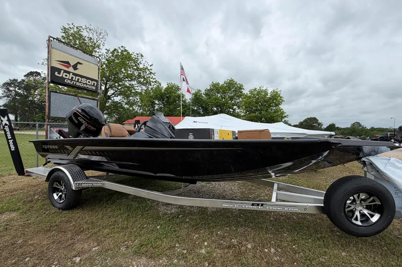 The Image of 2026 Xpress H18 Bass boat on trailer at Johnson Outdoors display. - 0
