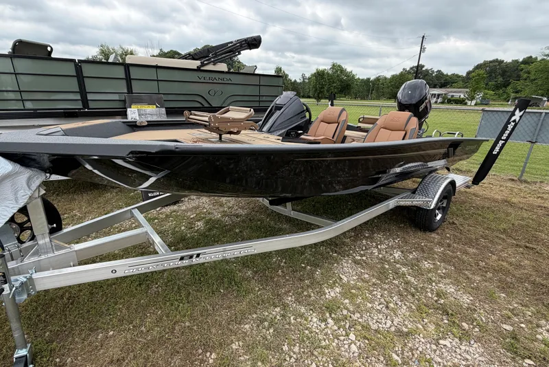 Slide: The Image of 2026 Xpress H18 Bass boat on trailer, parked outdoors, with sleek design and modern features. - 1
