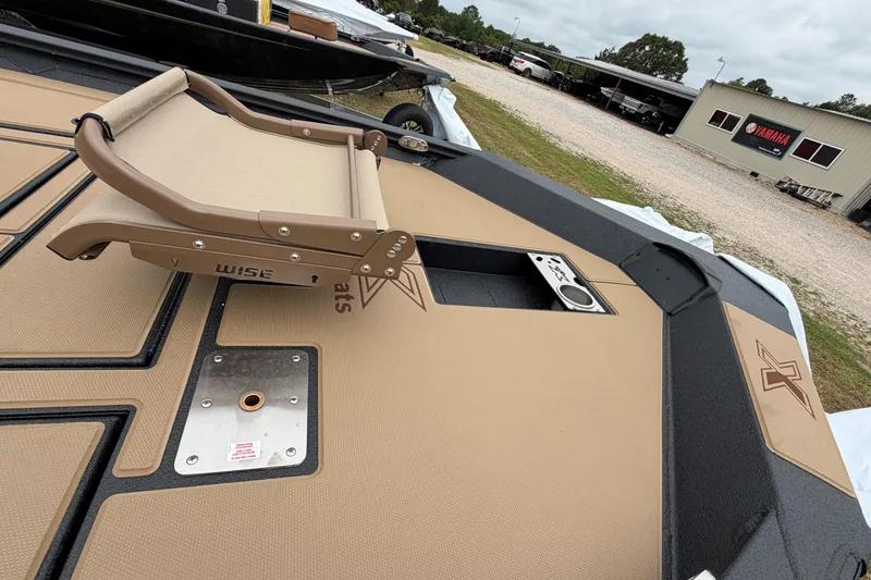 Slide: The Image of 2026 Xpress H18 Bass boat deck with tan seating and storage compartments. - 3