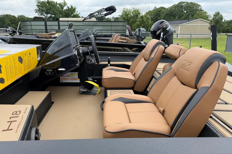 Slide: The Image of 2026 Xpress H18 Bass boat interior with tan leather seats and modern dashboard. - 6