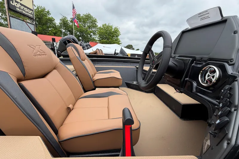 Slide: The Image of 2026 Xpress H18 Bass boat interior with tan seats and modern dashboard. - 7
