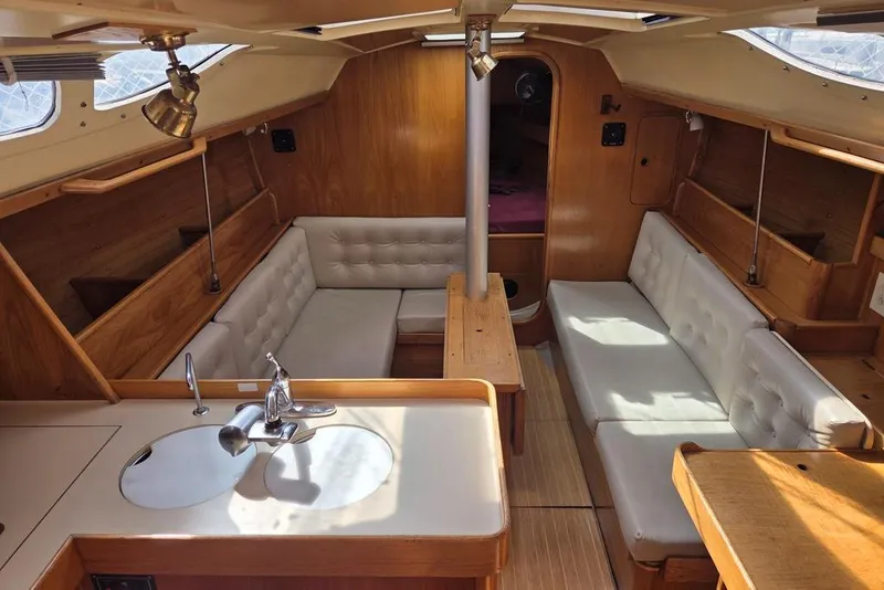 Slide: The Image of Salon 1988 Beneteau Oceanis 350 sailboat with rich wood finish and new off-white upholstery - 1