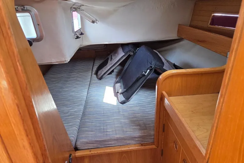 Slide: The Image of Beneteau Oceanis 350 spacious aft primary berth with storage and shelves - 4