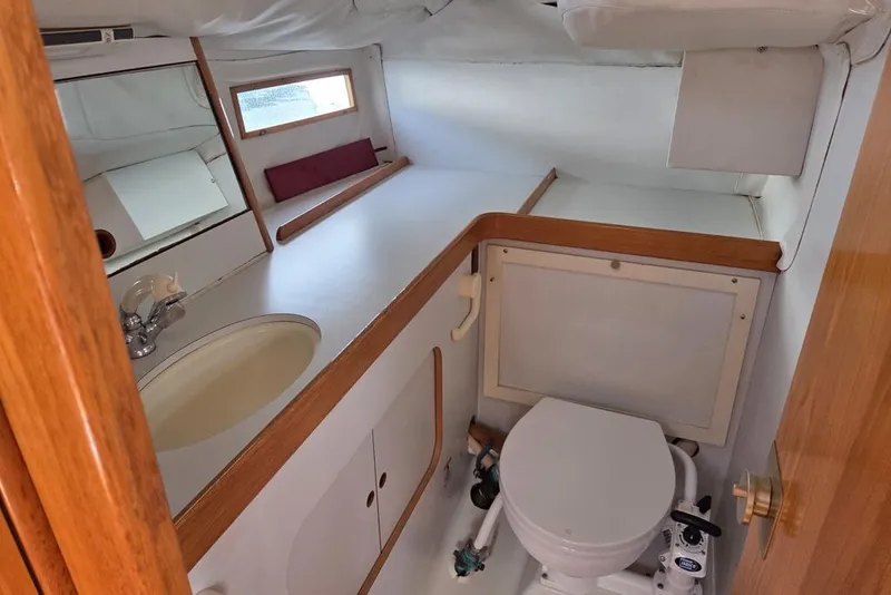 Slide: The Image of Interior of 1988 Beneteau Oceanis 350 head with sink, toilet, and shower head - 5