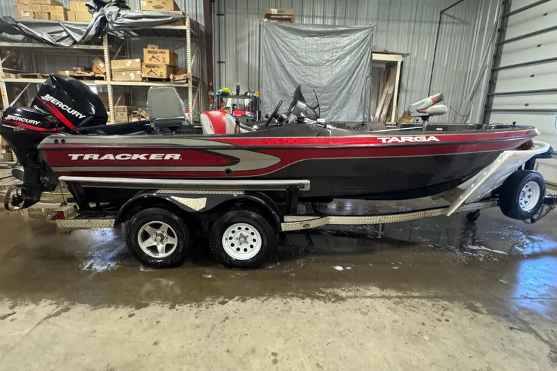 The Image of 2002 Tracker Targa 2000 boat on trailer in a garage setting. - 0