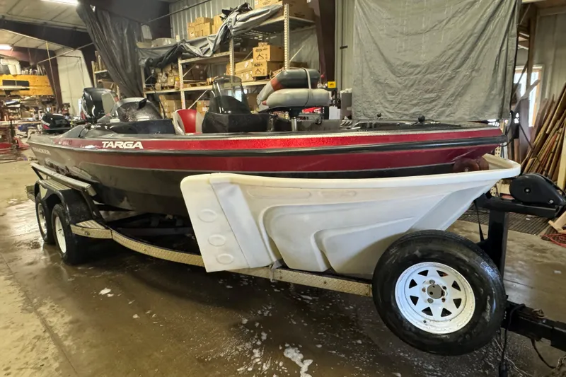 Slide: The Image of 2002 Tracker Targa 2000 boat on trailer in a workshop setting. - 2