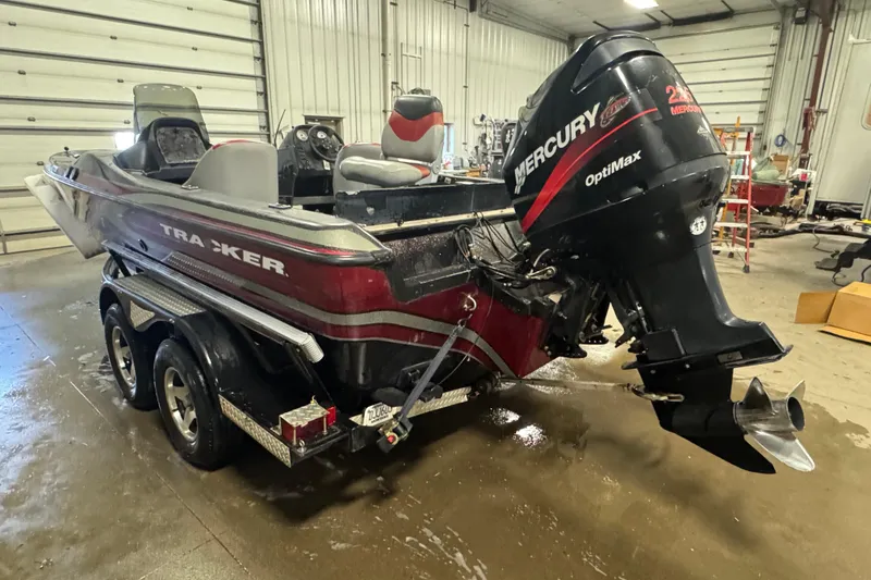 Slide: The Image of 2002 Tracker Targa 2000 boat with Mercury OptiMax engine in a garage setting. - 4